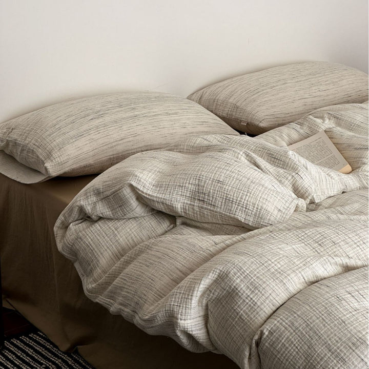 Cotton duvet cover set with fine pinstripes and subtle embroidery applications