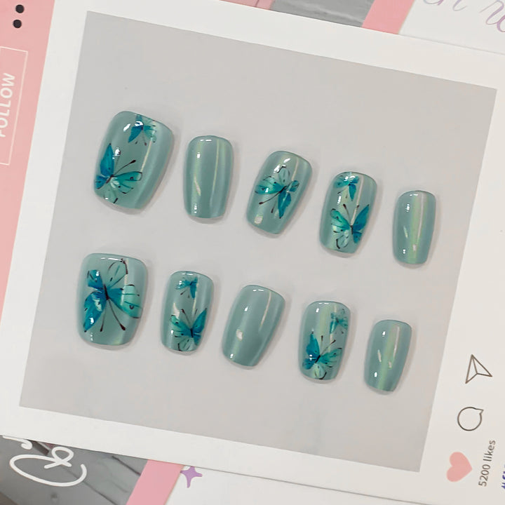 Artistic acrylic nails with butterfly motif Stornfield