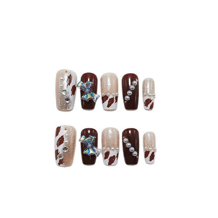 Artificial nails with glamorous rhinestone and bow design Stornfield
