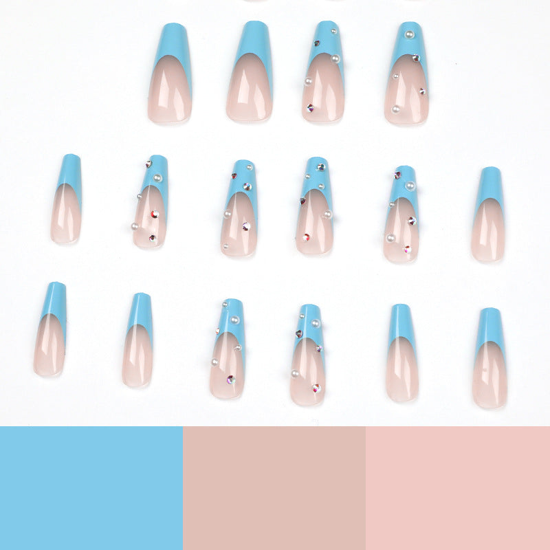 Artificial nail extensions with glitter and pearl accents Stornfield