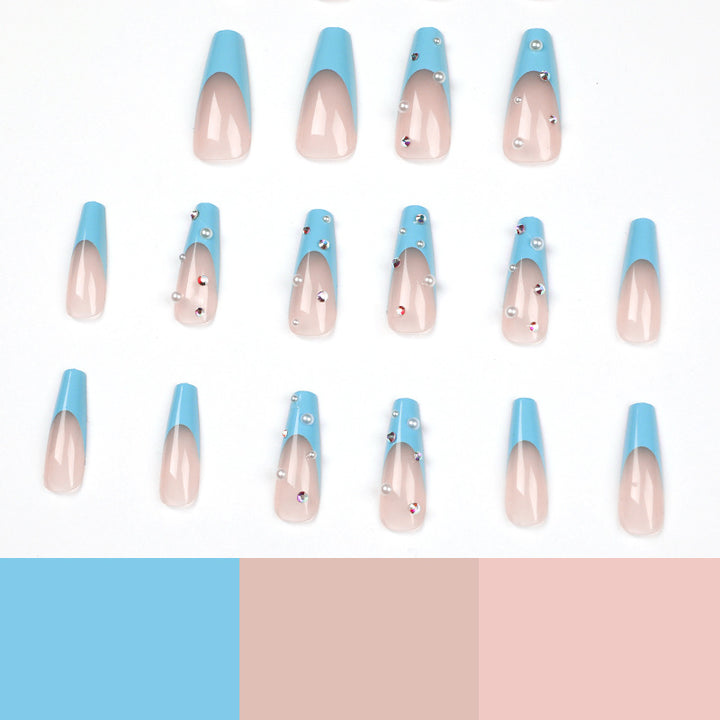 Artificial nail extensions with glitter and pearl accents Stornfield