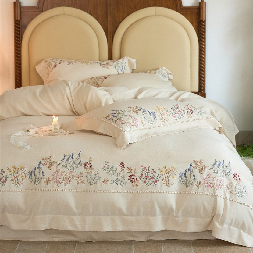 Romantic cotton satin duvet cover set with delicate floral embroidery and decorative pillow