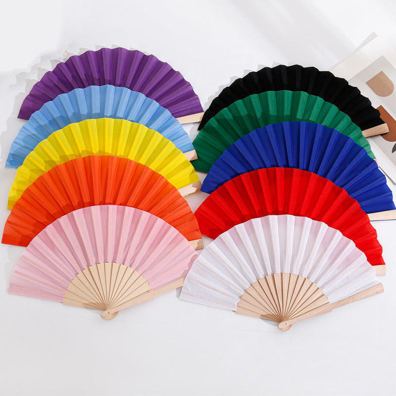 Ladies folding hand fan made of airy material with intricate folds Stornfield