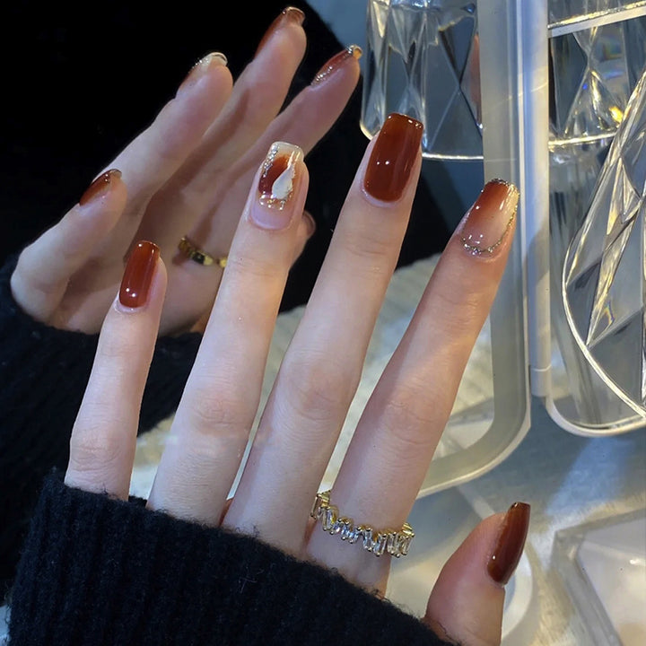 Elegant Glossy Press-On Nails with Gold Glitter Accents Stornfield