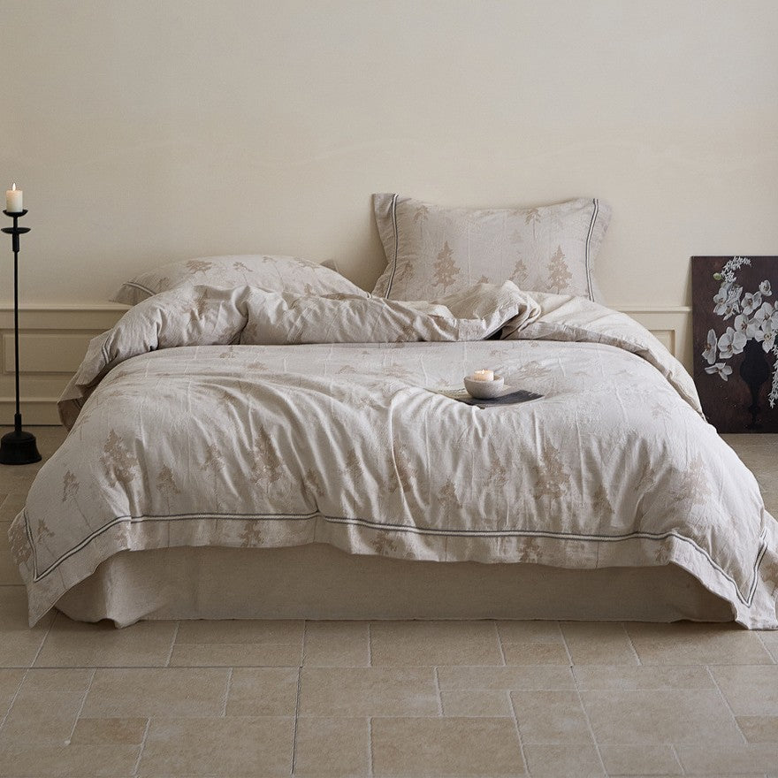 Linen bedding set with woven texture and subtle indigo border