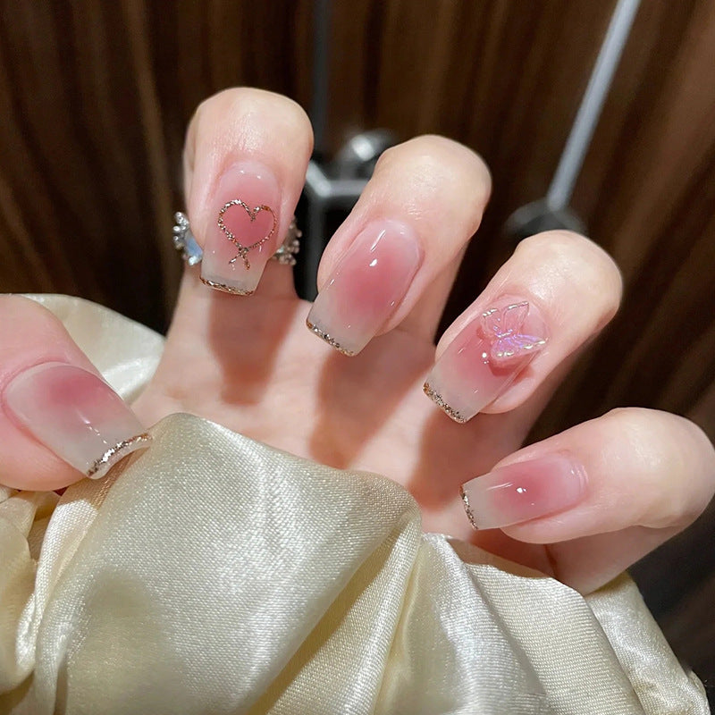 Glamorous artificial nails with heart and glitter details Stornfield