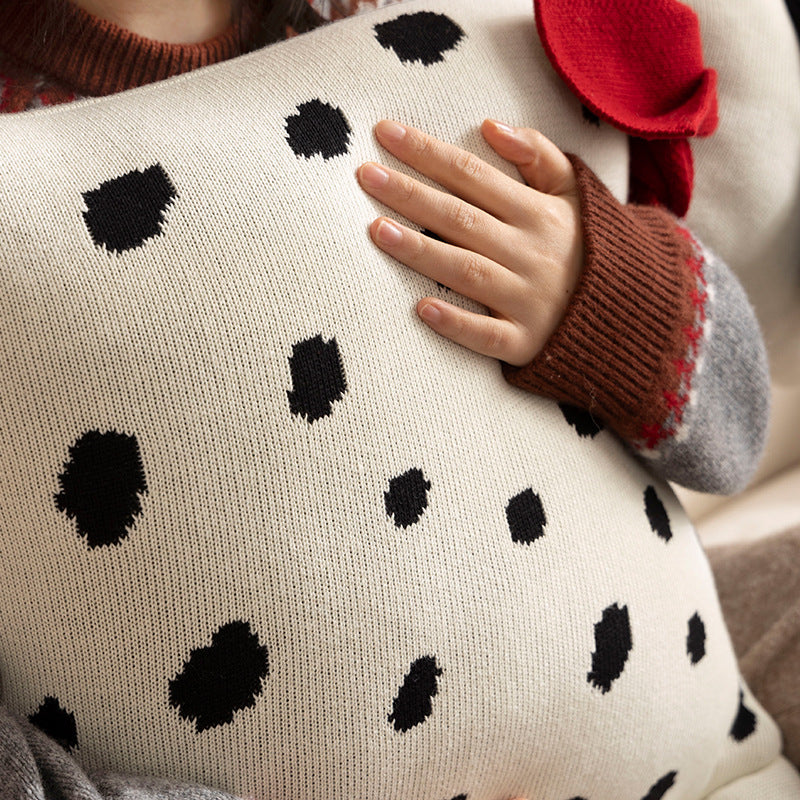 Decorative knitted cuddle pillow in the shape of a dog with a quilted body and bow detail Stornfield