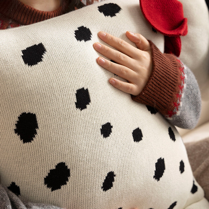 Decorative knitted cuddle pillow in the shape of a dog with a quilted body and bow detail Stornfield
