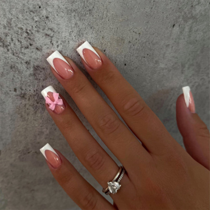 Acrylic nail set with elegant tips and playful bows Stornfield