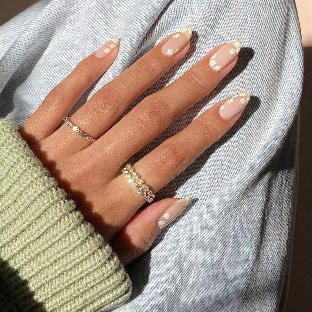 Artificial nail art with floral design and glitter accents Stornfield