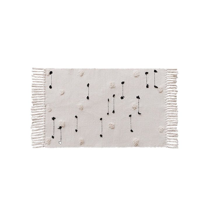 Hand-tufted bathroom mat with fringes, decorative dot-and-dash pattern and non-slip backing Stornfield