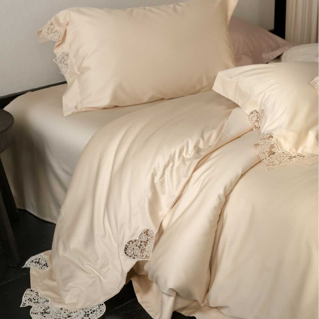 Satin bedding set with lace heart appliqué