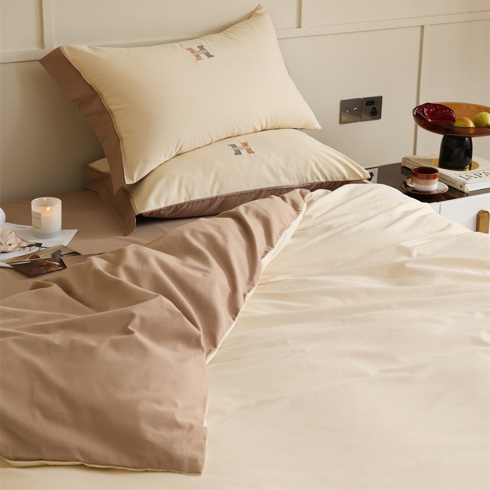 Luxurious cotton satin bedding set with contrasting piped edge and monogram embroidery