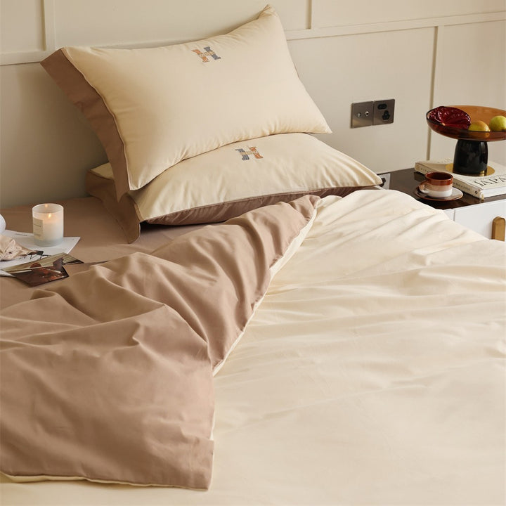 Luxurious cotton satin bedding set with contrasting piped edge and monogram embroidery