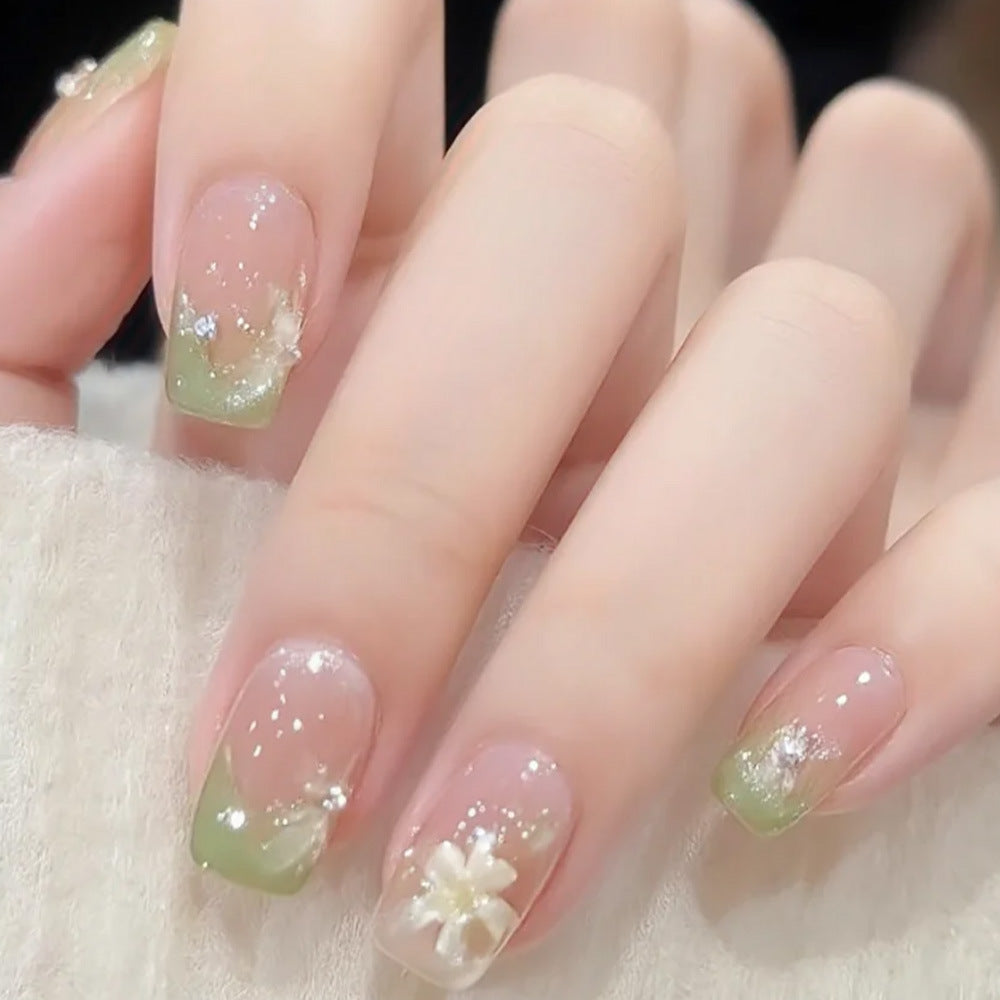 Artificial nails with floral accents and glitter coating Stornfield