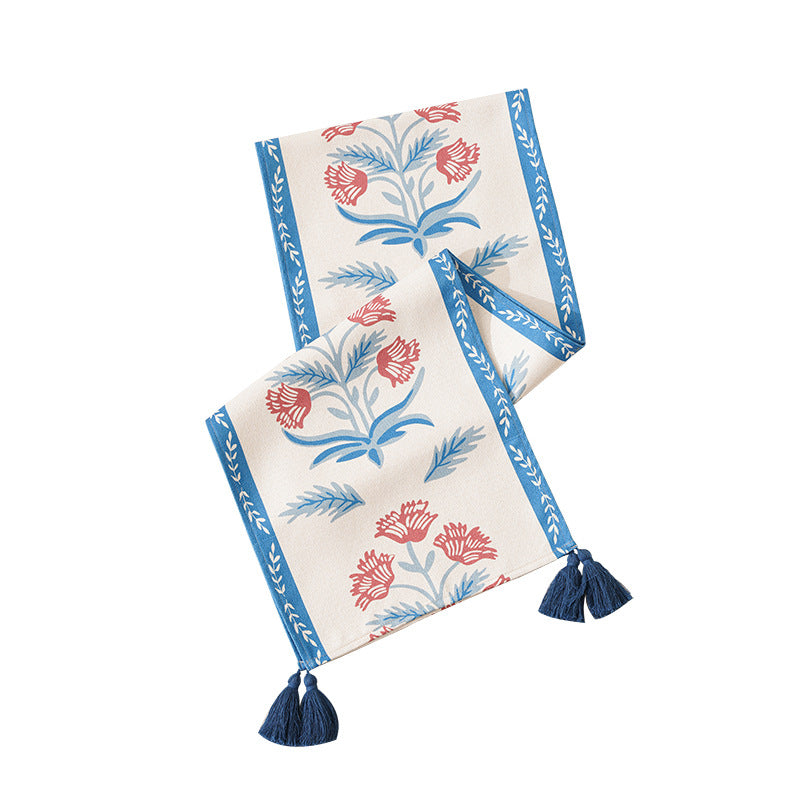 Table runner made of linen blend with floral block print motifs and tassels
