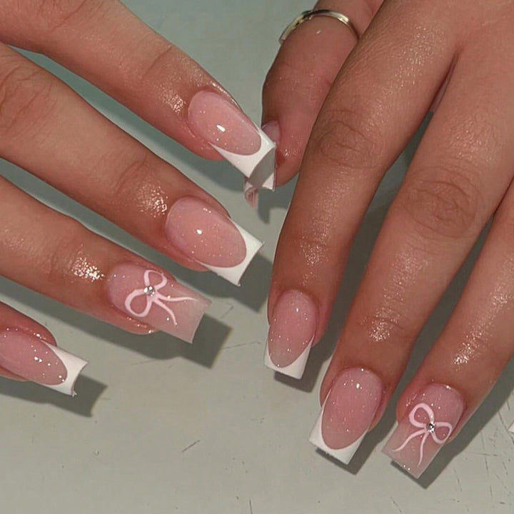 Nail art set with elegant bow and glitter accents Stornfield