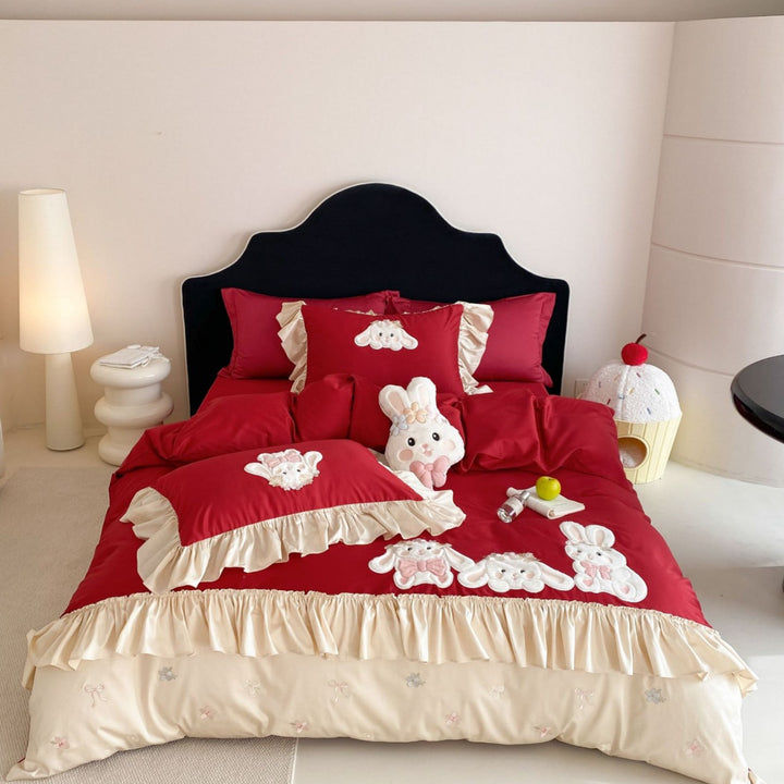Playful bedding set with ruffles, three-dimensional appliqués, and delicate embroidery
