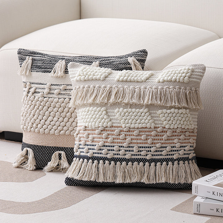High-structured woven decorative cushion cover with fringes and bouclé application