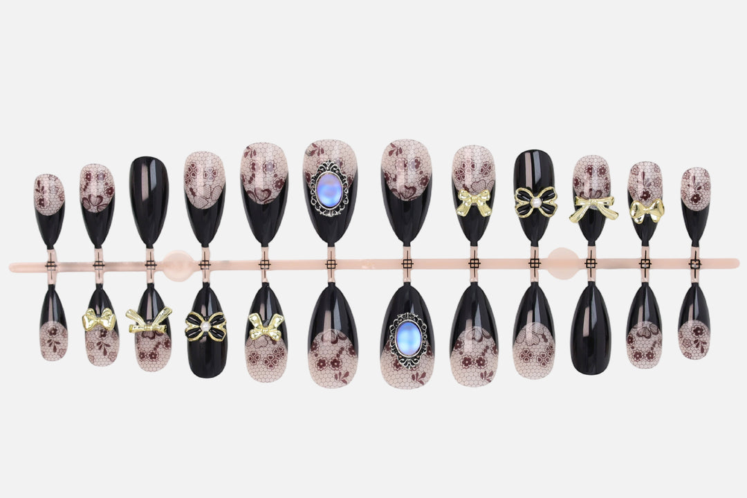 Artificial nail set with elegant dot and bow decorations Stornfield