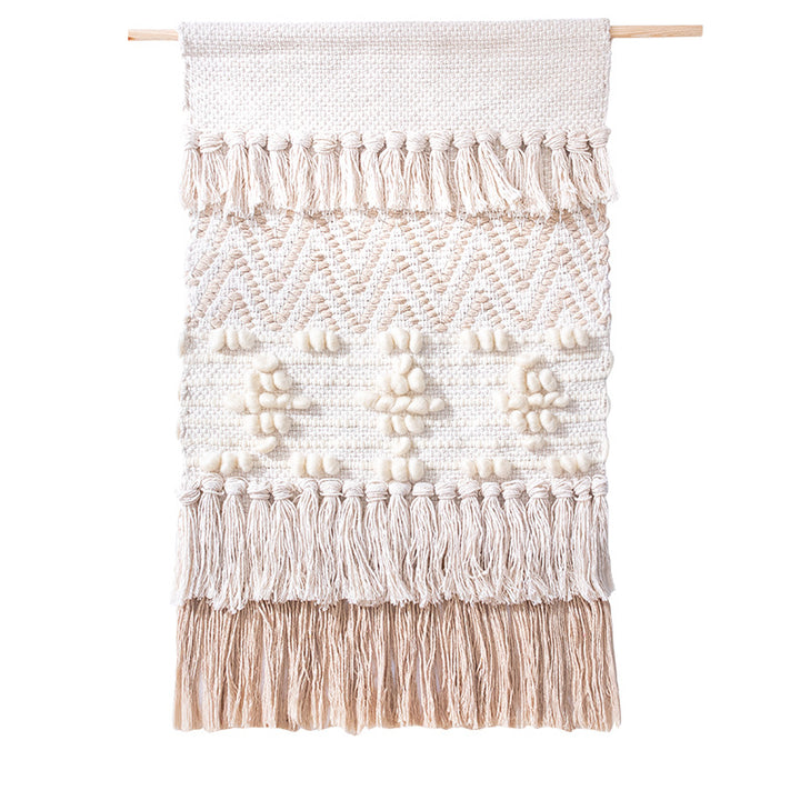 Handwoven wall hanging in boho style with tassels and geometric structure