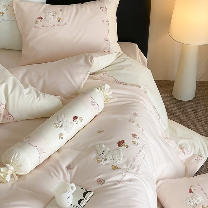 Playful cotton bedding set with plush bunny appliqué and round cushion