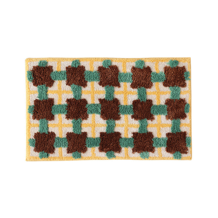 Hand-tufted bathroom bath mat with non-slip backing and textured square relief Stornfield