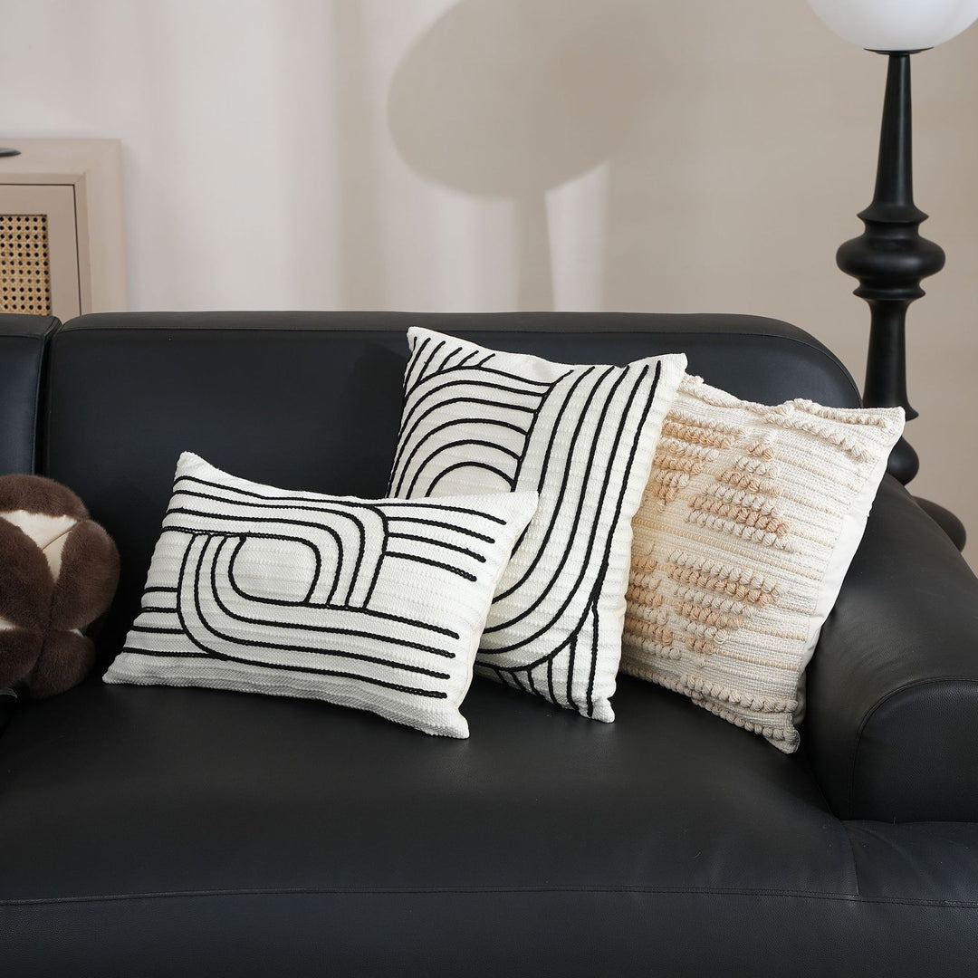 Decorative cushion cover with textured embroidery and geometric line motif