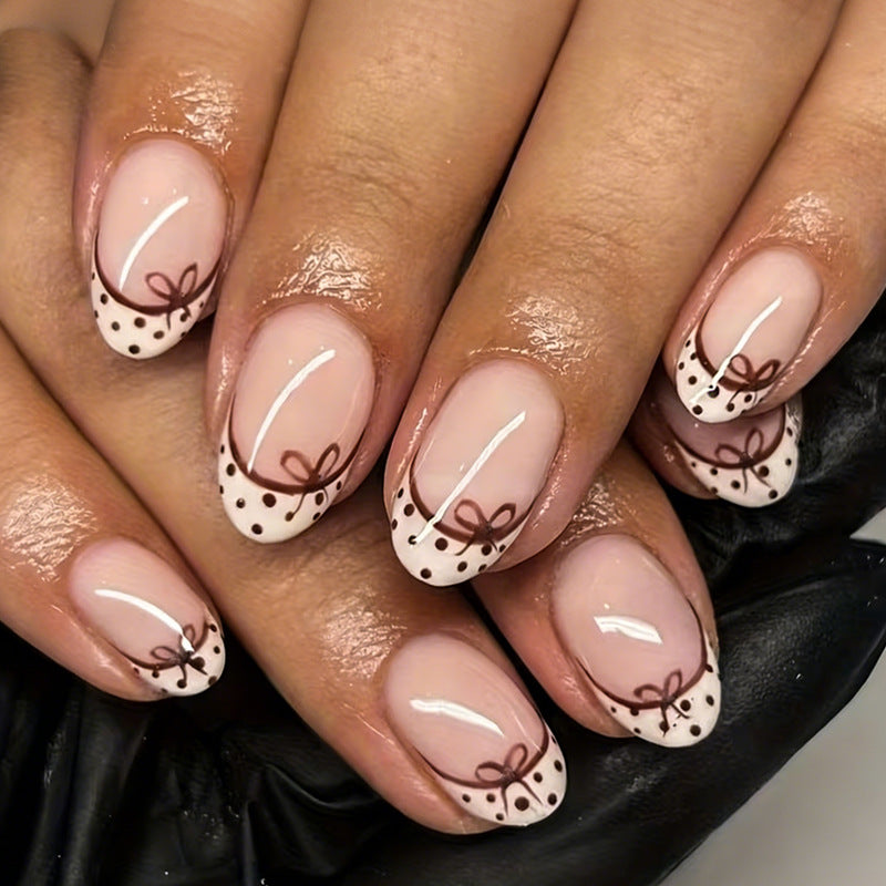 Artificial nail set with elegant bow and dot patterns Stornfield