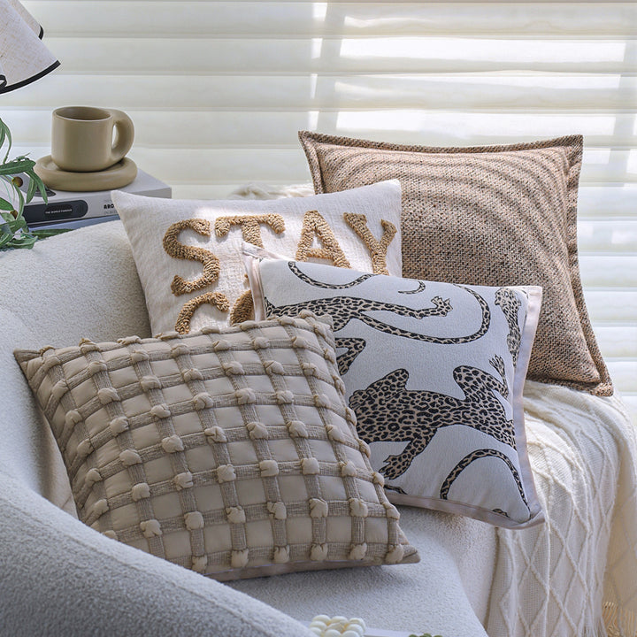 Square decorative cushion cover made of mottled bouclé weave with subtle piping Stornfield