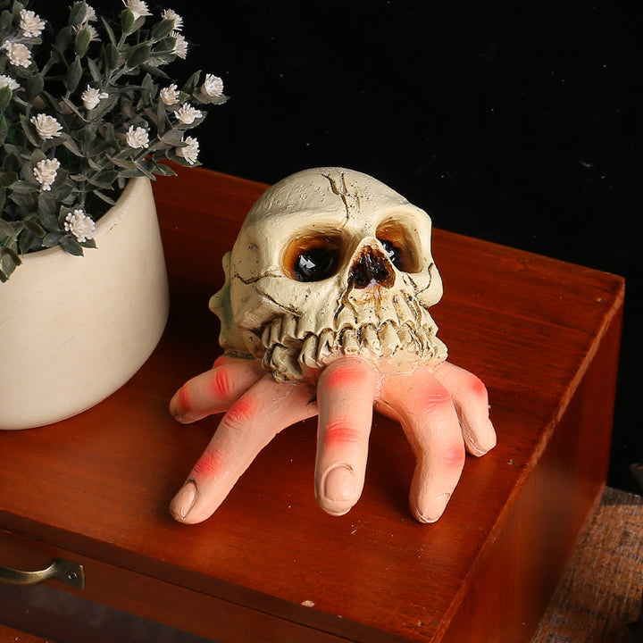 Detailed Halloween decoration sculpture skull with grasping hand