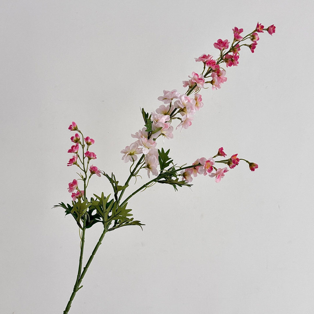 Artificial flower branch with intricately detailed red flowers