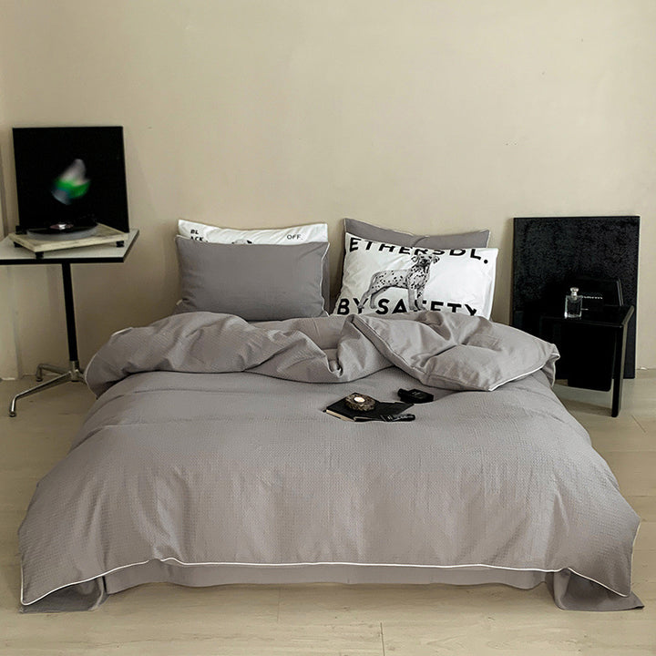 Textured cotton waffle duvet cover with pillowcases and fine contrasting piping