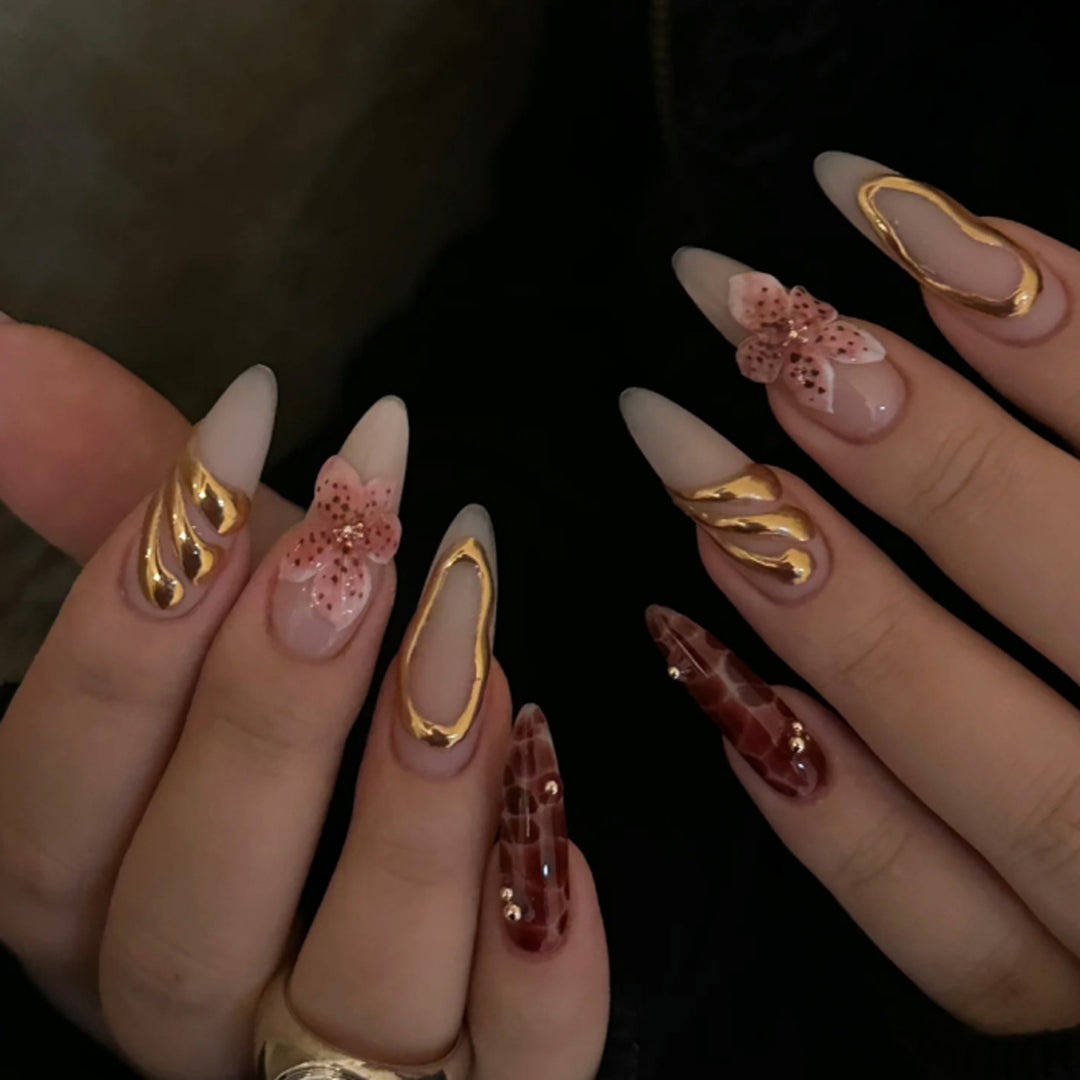 Artful stiletto nails with elegant floral designs and glitter accents Stornfield