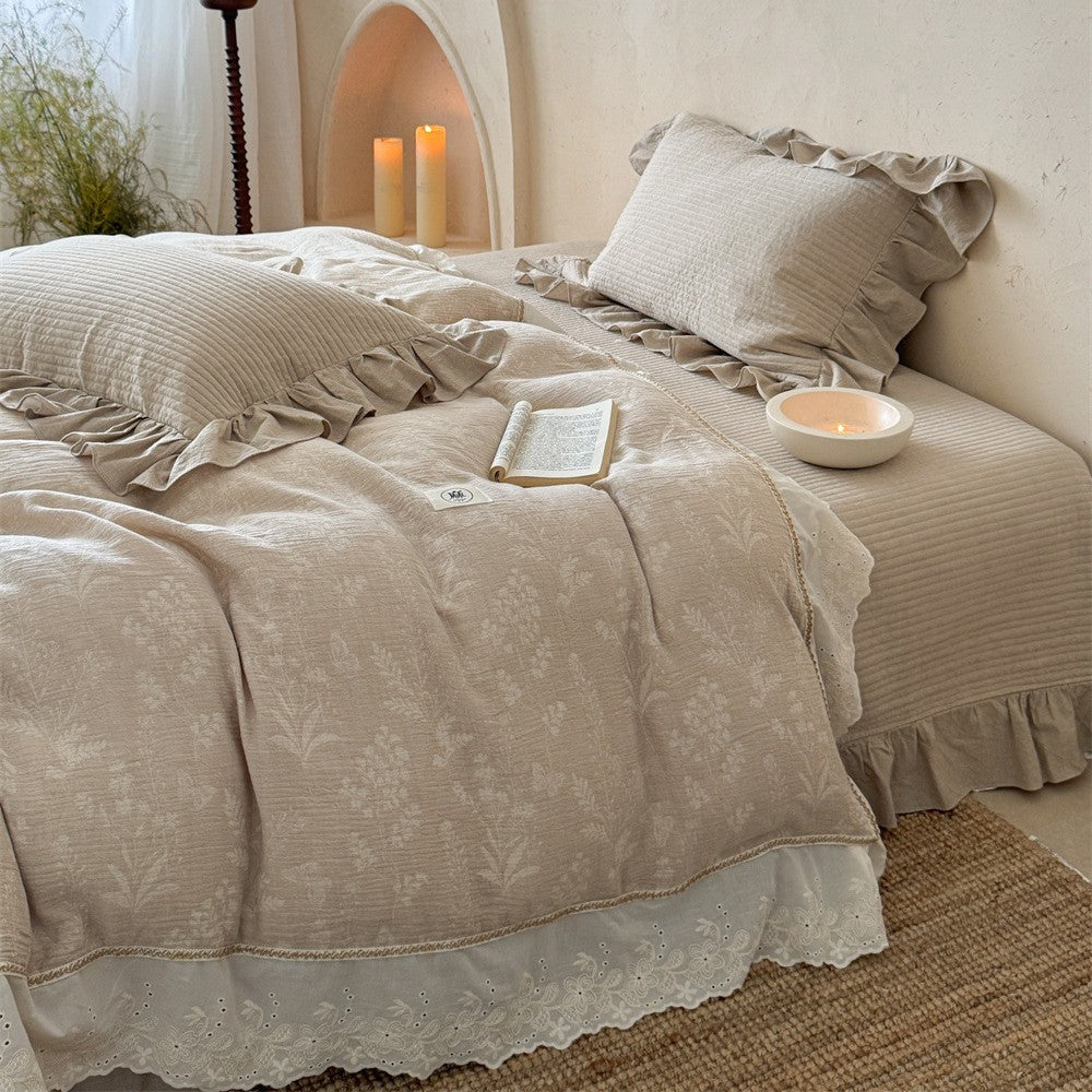 Luxurious quilted cotton bedding set with ruffles and embroidered details
