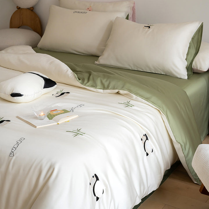 Luxurious satin bedding set with embroidered cherry motifs, reversible function and plush bunny pillow