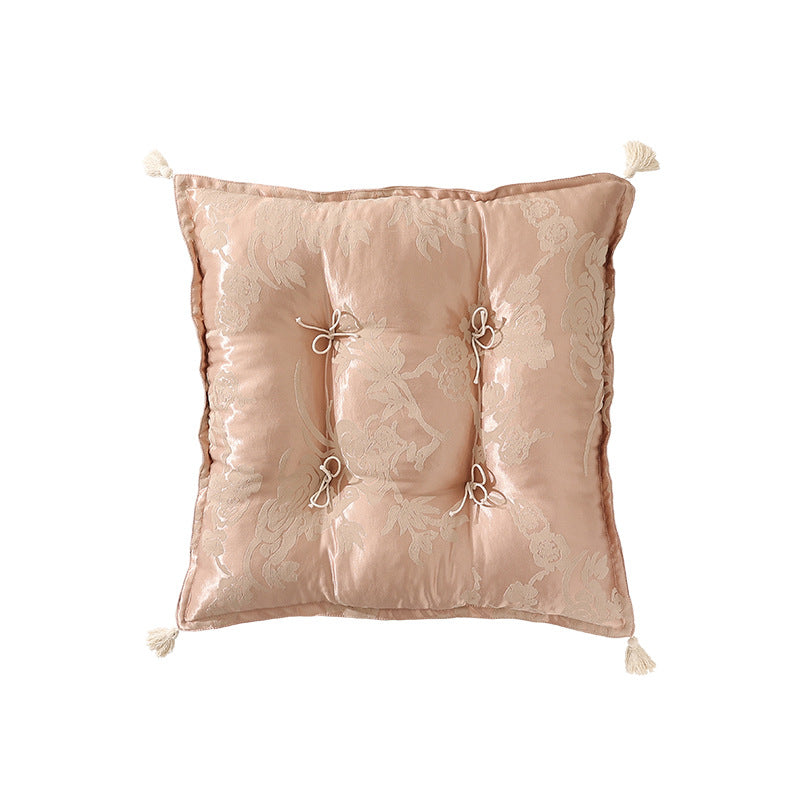 Padded floor cushion with quilted tufting and tassels