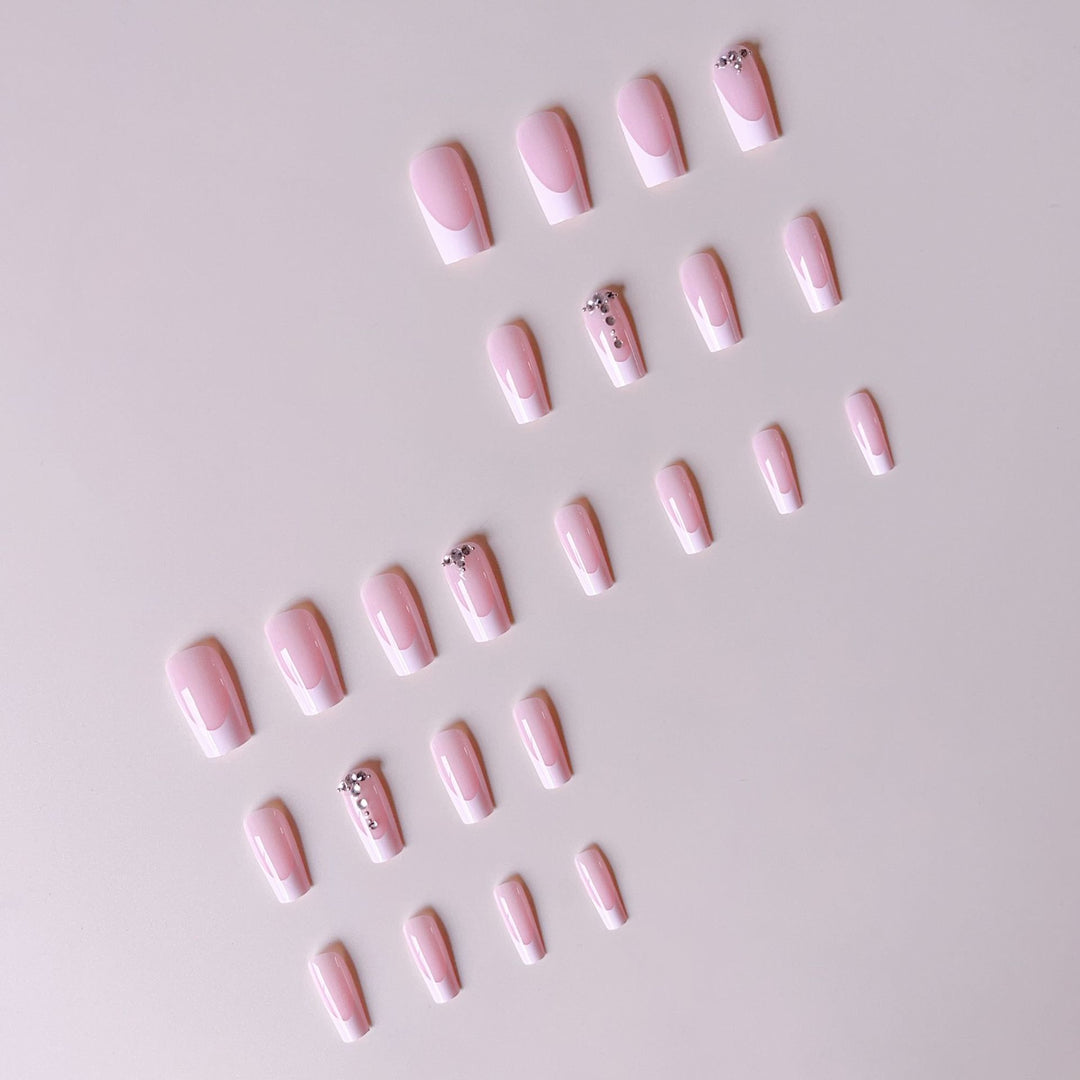 Acrylic nail set with elegant French tips and sparkling rhinestone accents Stornfield