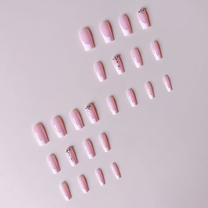 Acrylic nail set with elegant French tips and sparkling rhinestone accents Stornfield