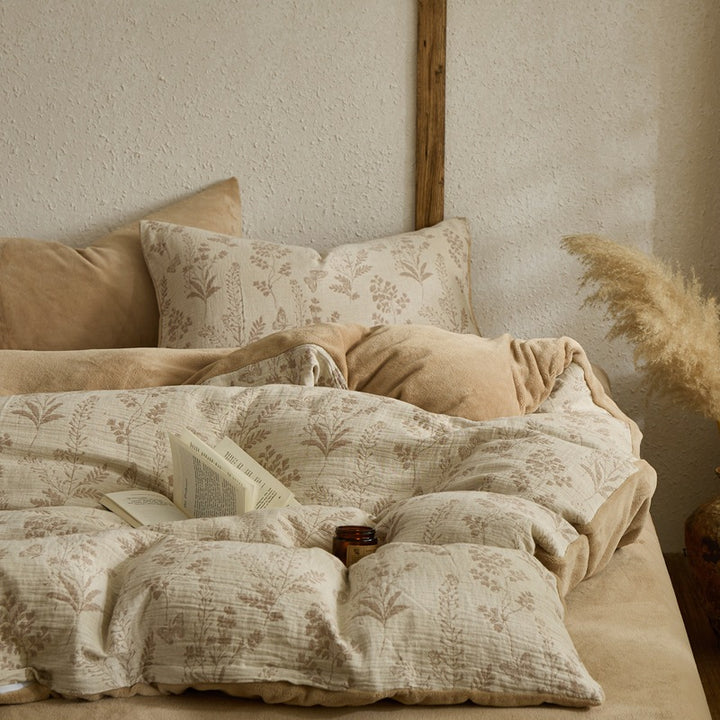 Quilted reversible bed with floral muslin surface and plush fleece back