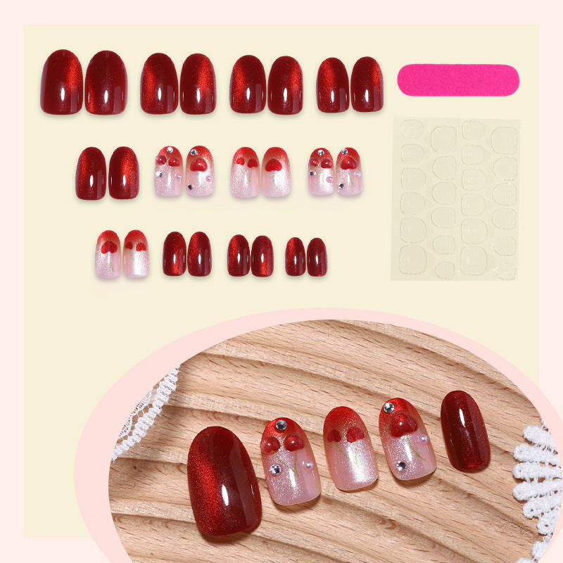 Artificial nail set with glamorous accents and creative heart motifs Stornfield