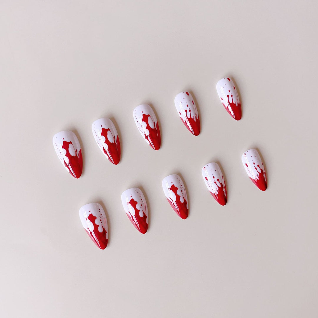 Artificial nail set with blood red inspired design and pointed accents Stornfield