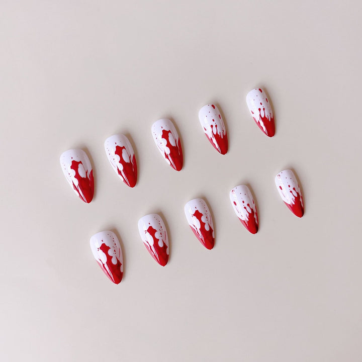 Artificial nail set with blood red inspired design and pointed accents Stornfield