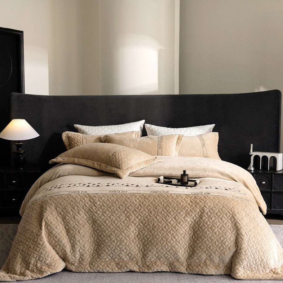 Quilted bedding set with geometric quilting and decorative ribbon