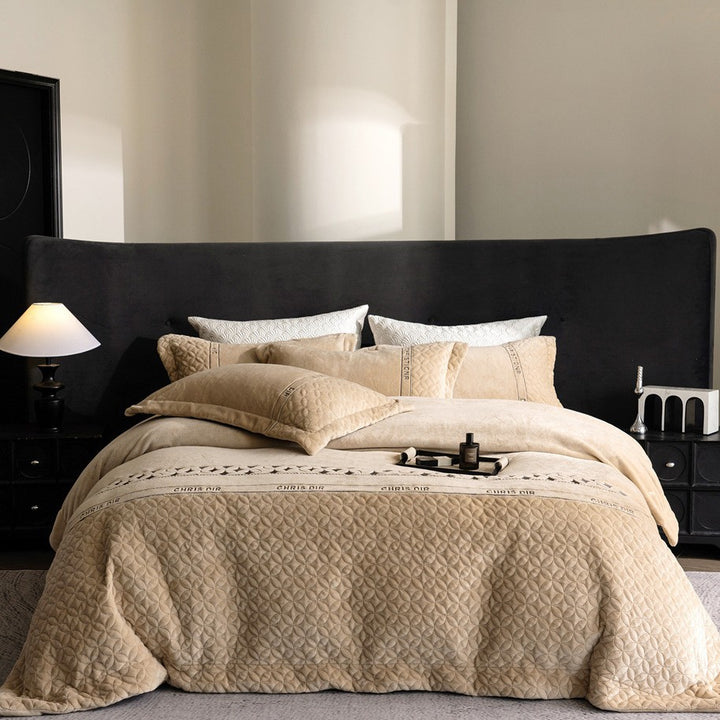 Quilted bedding set with geometric quilting and decorative ribbon