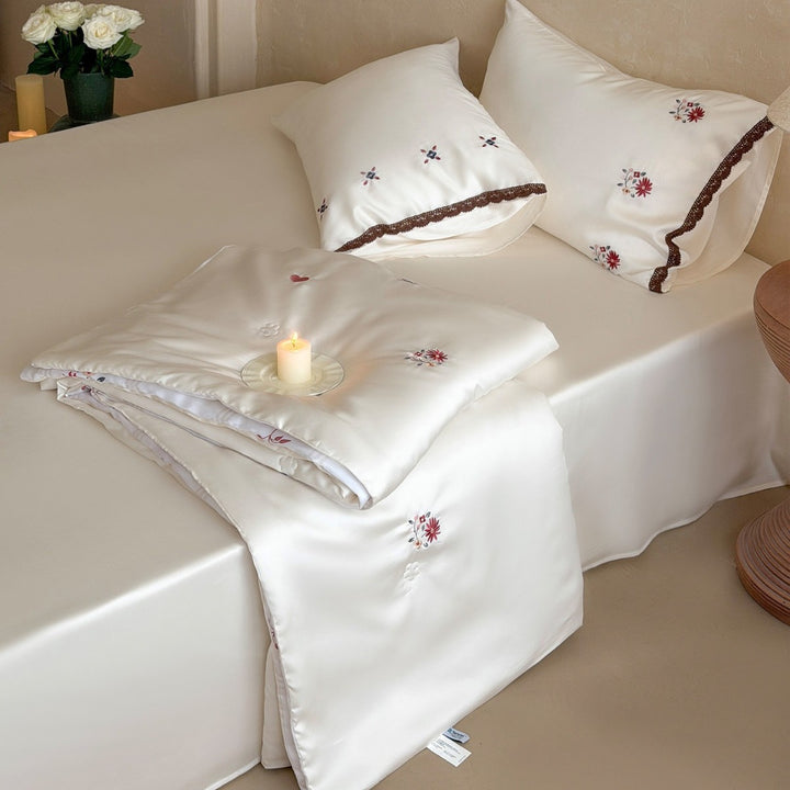 Elegant satin bedding set with fine floral embroidery and lace trim