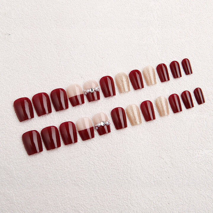 Glamorous artificial nails with glitter and pearl decorations Stornfield