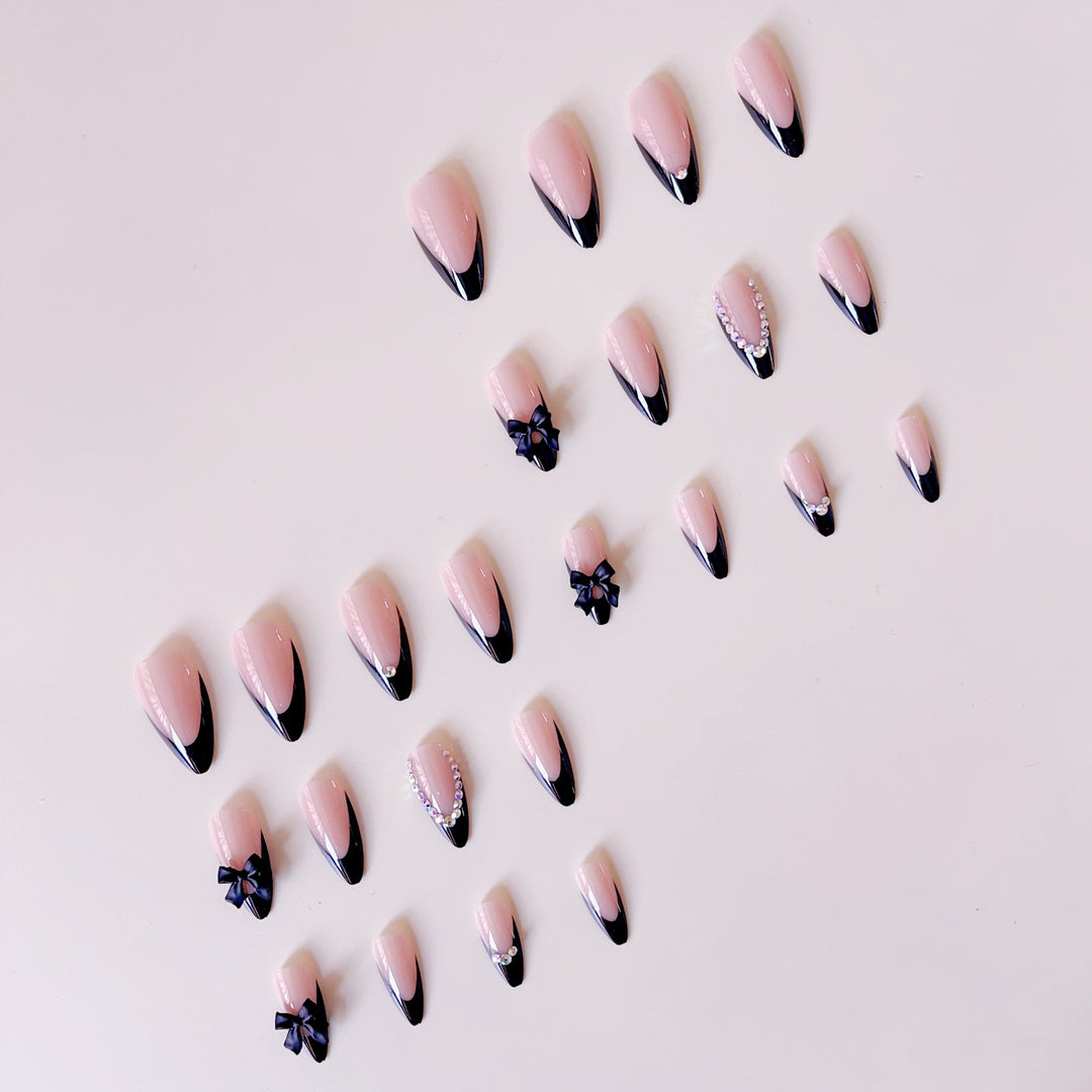 Artificial nail set with glamorous 3D bows and rhinestone embellishments Stornfield