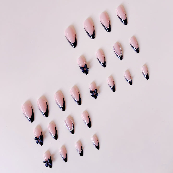 Artificial nail set with glamorous 3D bows and rhinestone embellishments Stornfield