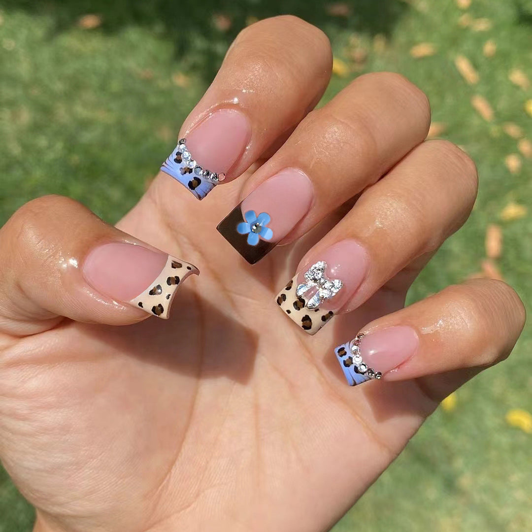Artificial nails with stylish animal patterns and sparkling accents Stornfield